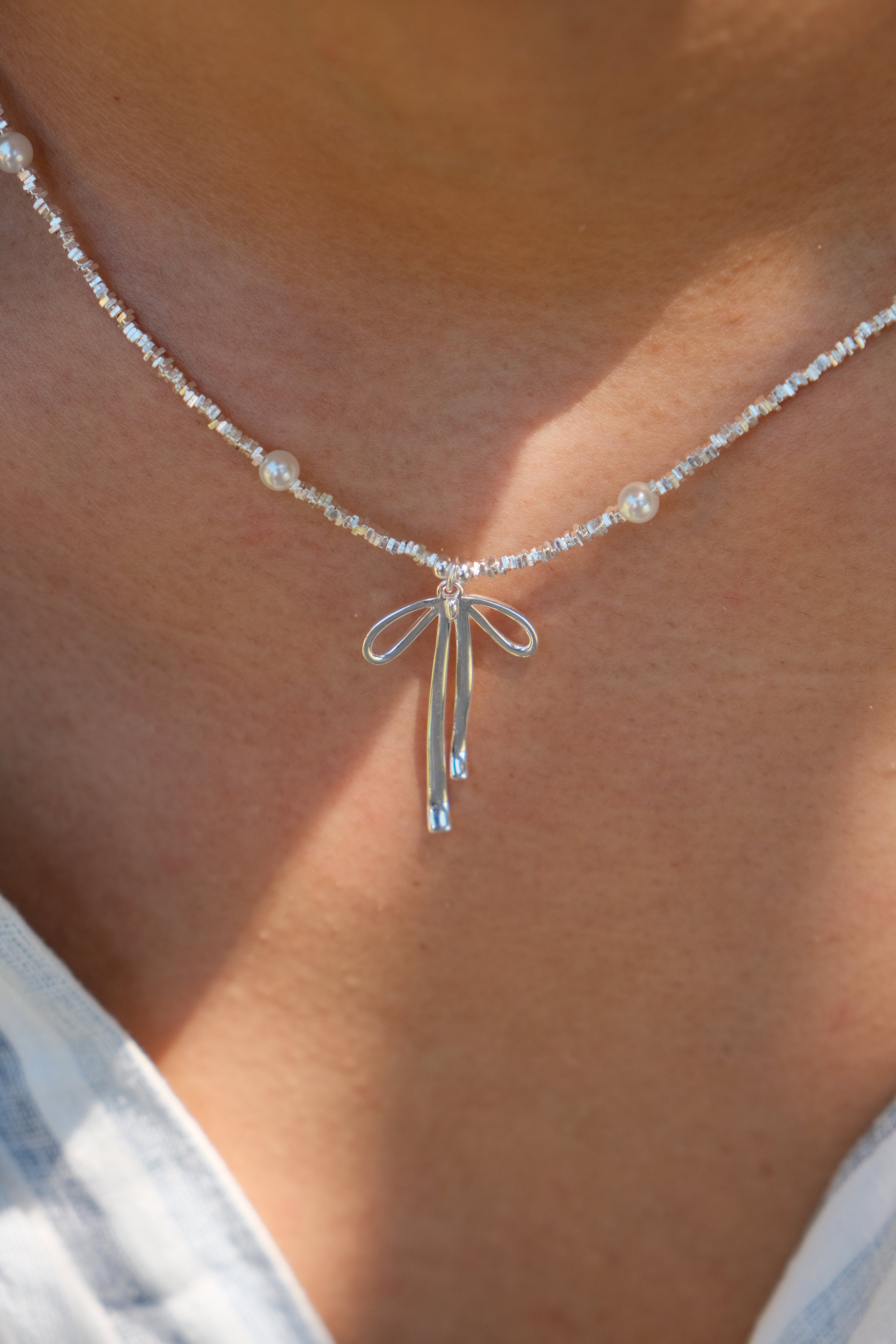 Silver necklace with a bow pendant